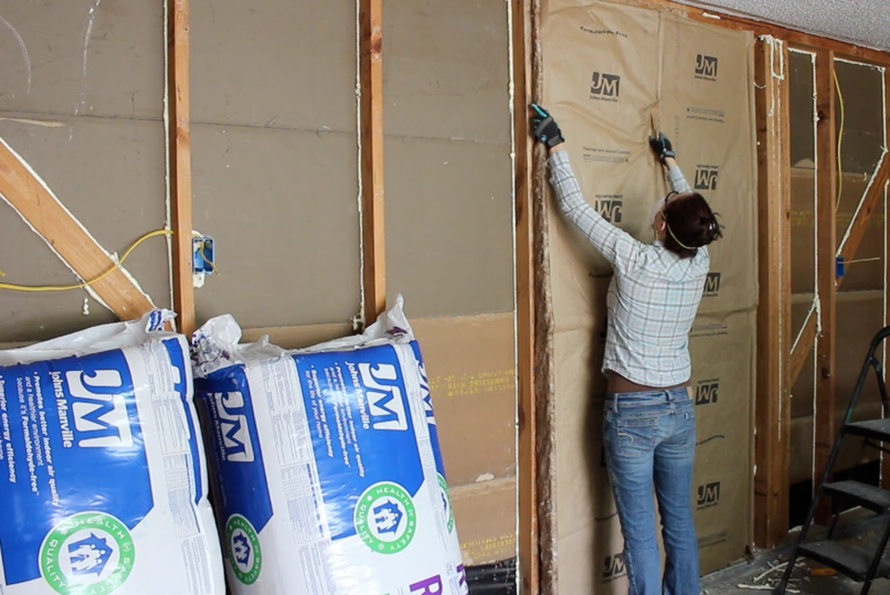 a woman putting up installation in a garage