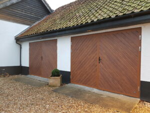 Side hinged garage doors are used extensively in garage conversions when keeping heat inside the home is a priority