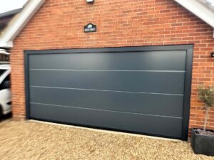 Anthracite double garage door on a brick garage