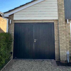 Anthracite grey coloured garage door with white cladding above