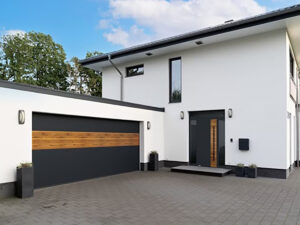 Grey garage door with one of its panels in a different design